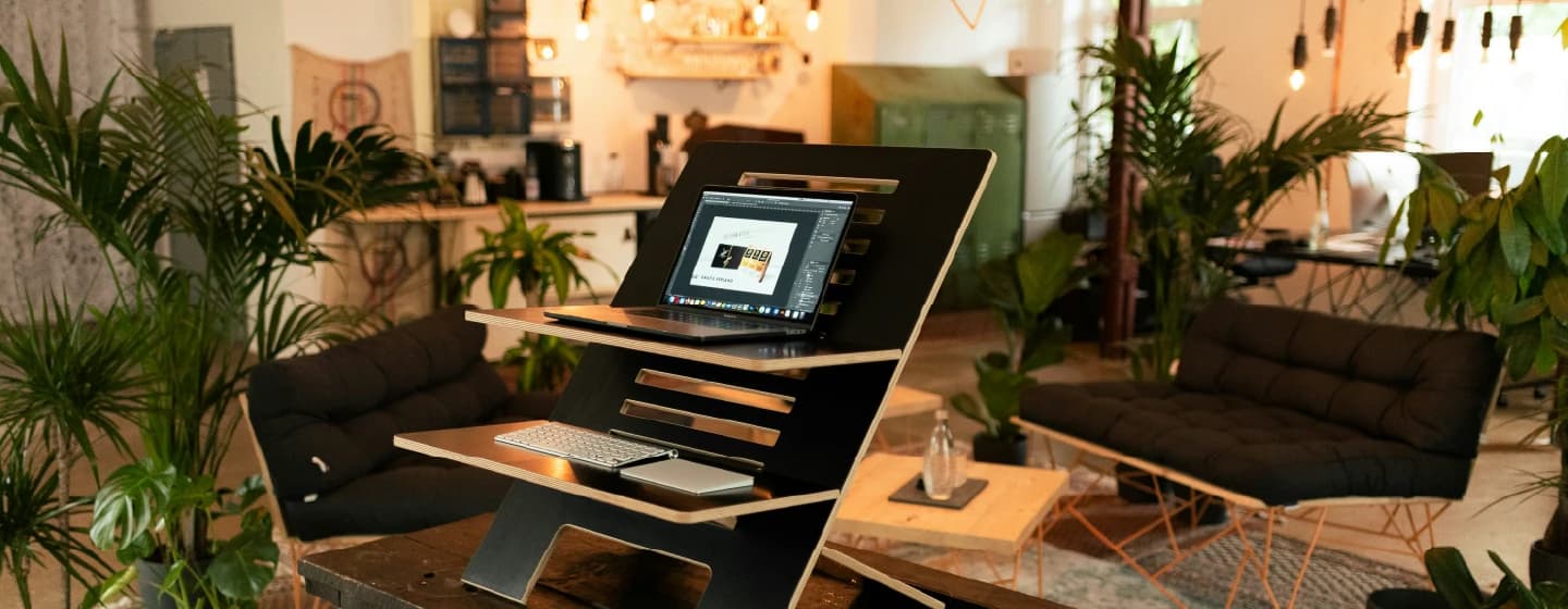 a modern workplace with plants and sustainable lighting and furniture