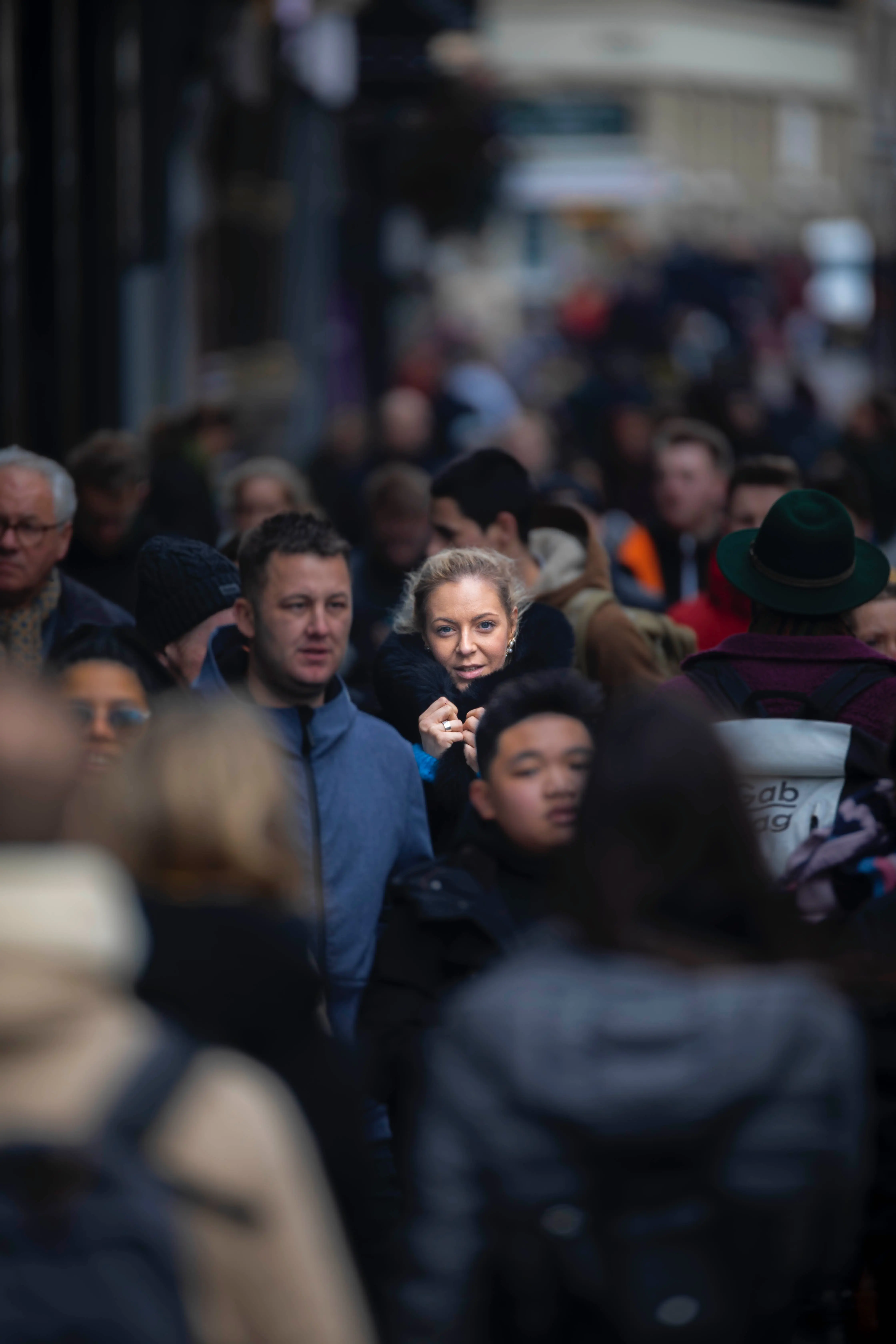 A crowd of people walking down a street.