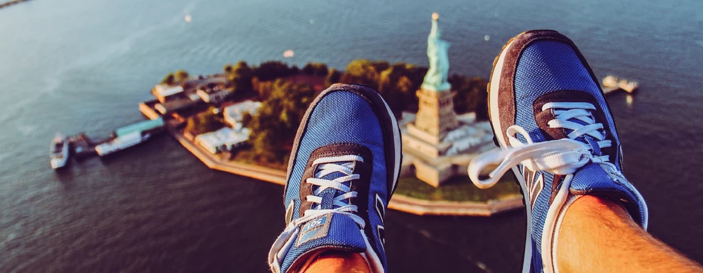 a man parasailing over statue of liberty representing sylvain joining the fireifsh usa team