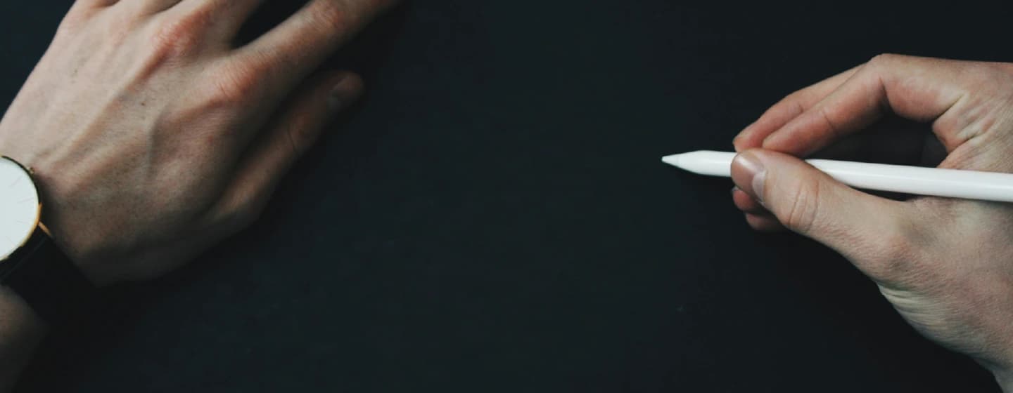 a man writing about to write on a blank page